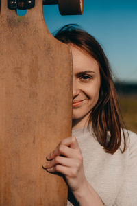 Midsection of young woman holding heart shape