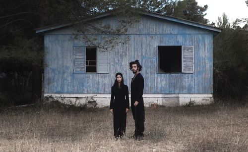 Portrait of couple standing by old building