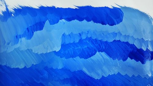 Low angle view of ice against blue sky