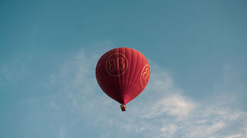 Low angle view of balloons flying against sky