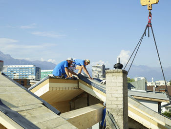 Workers at construction site working on rooftop