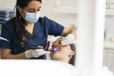 Dentist examining woman