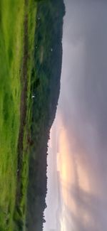 Scenic view of land against sky during sunset