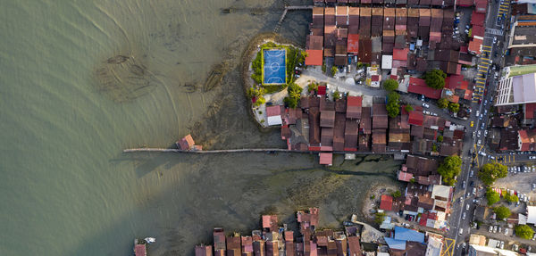 High angle view of boats in sea against buildings