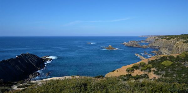 Scenic view of sea against blue sky