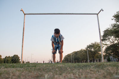 Man standing on field against clear sky