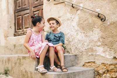 Cute sibling sitting on staircase