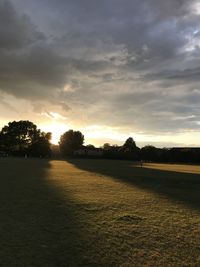 Scenic view of field against sky during sunset