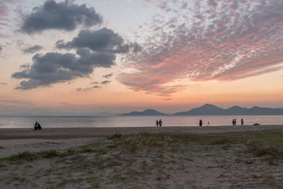 Scenic view of beach against sky during sunset