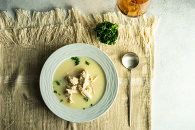 Traditional georgian chicken soup chikhirtma served in ceramic bowl with coriander herb