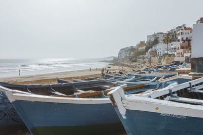 Boats in sea against clear sky