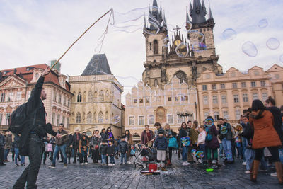 Group of people in front of historic building in city