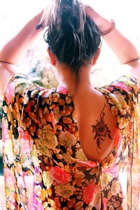 Rear view of woman with tattoo on back