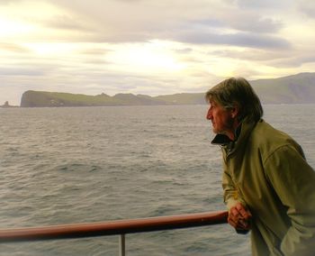 Man looking at sea against sky