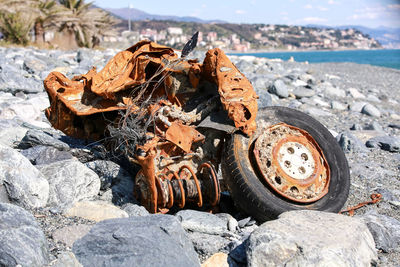 Abandoned motorcycle at beach during sunny day