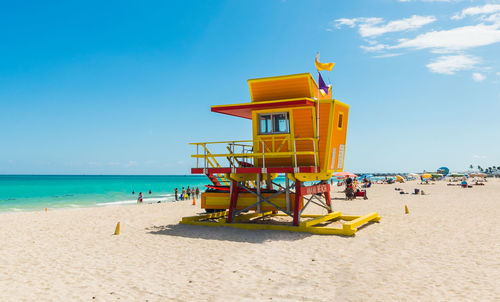 Lifeguard hut on beach against sky