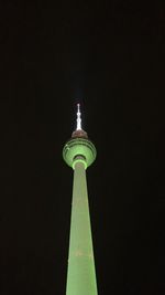 Low angle view of communications tower at night