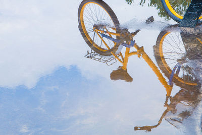 Reflection of bicycle in puddle