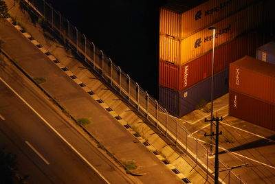 Aerial view of containers by a highway at night