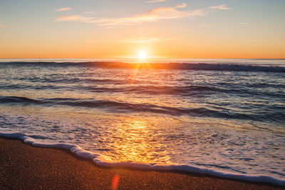 View of calm beach at sunset