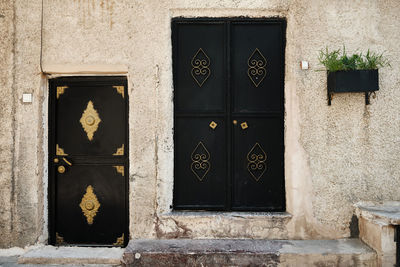 Entrance doors of middle eastern stone house.metal doors decorated with copper colored wrought metal