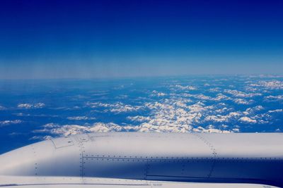 Cropped airplane against scenic blue sky