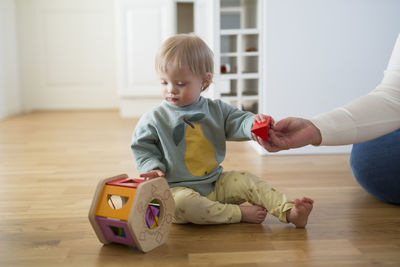 Boy playing with toy at home