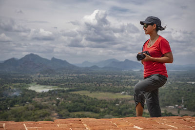 Woman taking picture on the top of the rock fortress of sigiriya