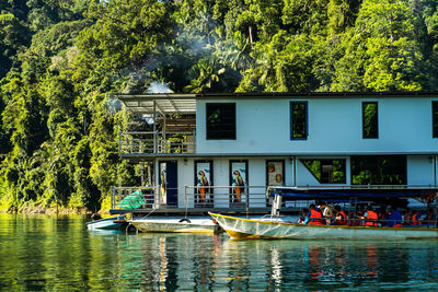 People in lake against trees