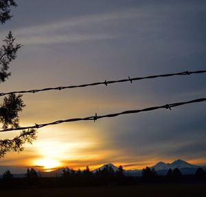 Scenic view of landscape against sky at sunset