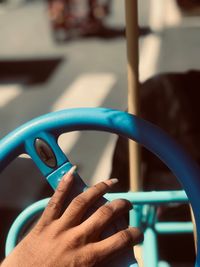 Close-up of woman hand holding steering wheel