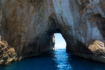 Scenic view of sea seen through cave