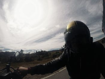 People on road against cloudy sky