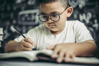 Close-up of boy with book