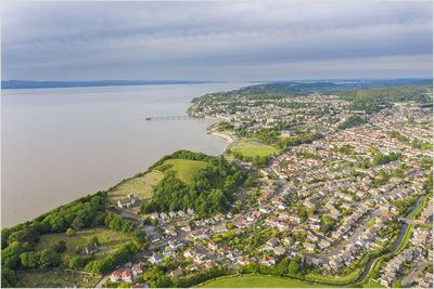 High angle view of townscape by sea against sky