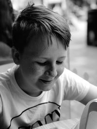 Close-up of smiling boy looking down