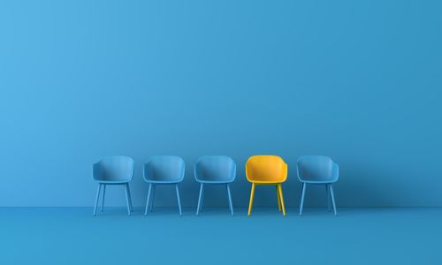 Empty chairs and table against blue wall