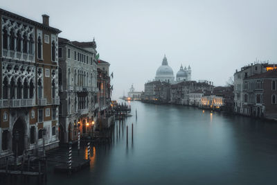 Canal amidst buildings in city