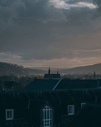 High angle view of buildings against cloudy sky at dusk