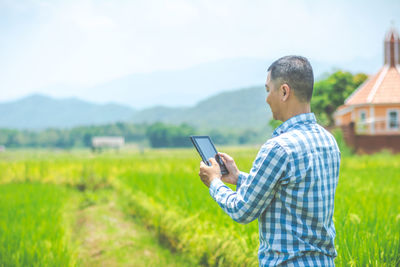  side view of man using digital tablet