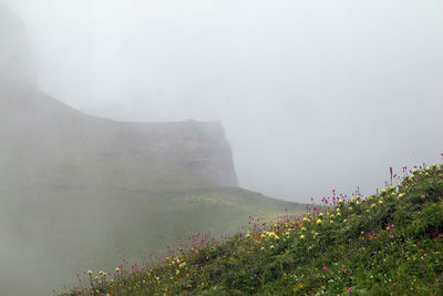 Scenic view of mountains against sky during foggy weather