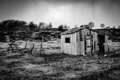 Abandoned house on field