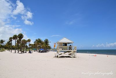 Lifeguard hut on beach against sky