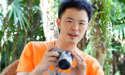 Portrait of young man photographing