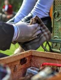 Midsection of man working on wood