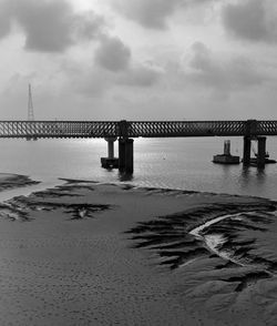 Bridge over sea against sky