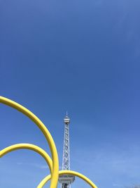 Low angle view of ferris wheel against blue sky