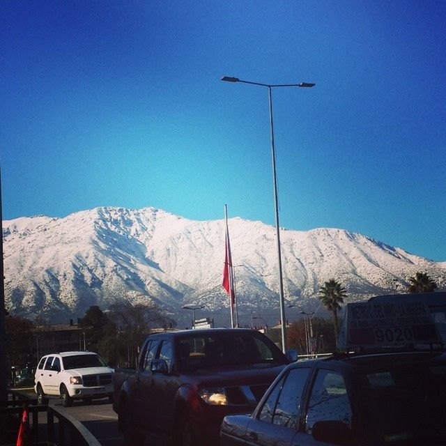 snow, mountain, winter, cold temperature, transportation, mountain range, snowcapped mountain, season, clear sky, weather, mode of transport, car, scenics, blue, beauty in nature, land vehicle, road, landscape, nature, tranquil scene