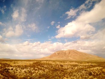 Scenic view of mountains against cloudy sky