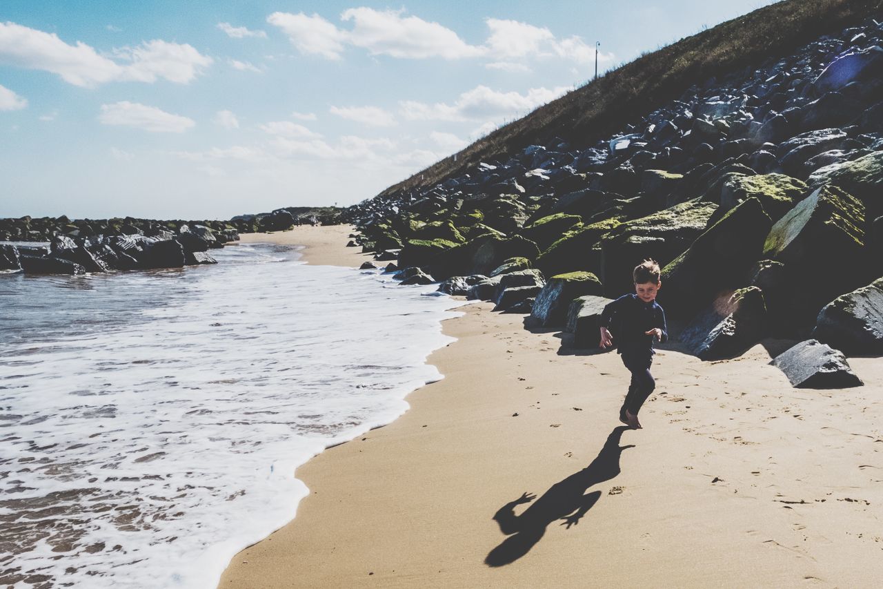 beach, water, land, sand, nature, real people, sky, sea, sunlight, beauty in nature, lifestyles, leisure activity, day, people, cloud - sky, motion, shadow, men, outdoors